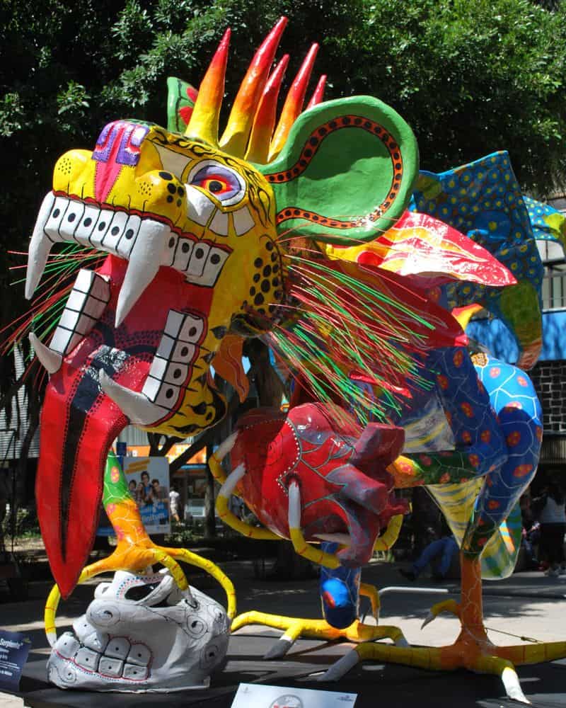 colorful alebrije statue, which is a hybrid animal, that was on a float during the Mexico City Day of the Dead parade