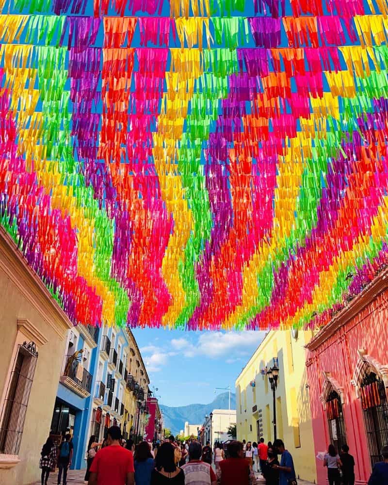 colorful flags hung above the street in downtown oaxaca city mexico